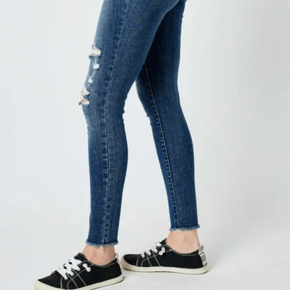 Side profile showcasing the skinny fit and knee distressing.