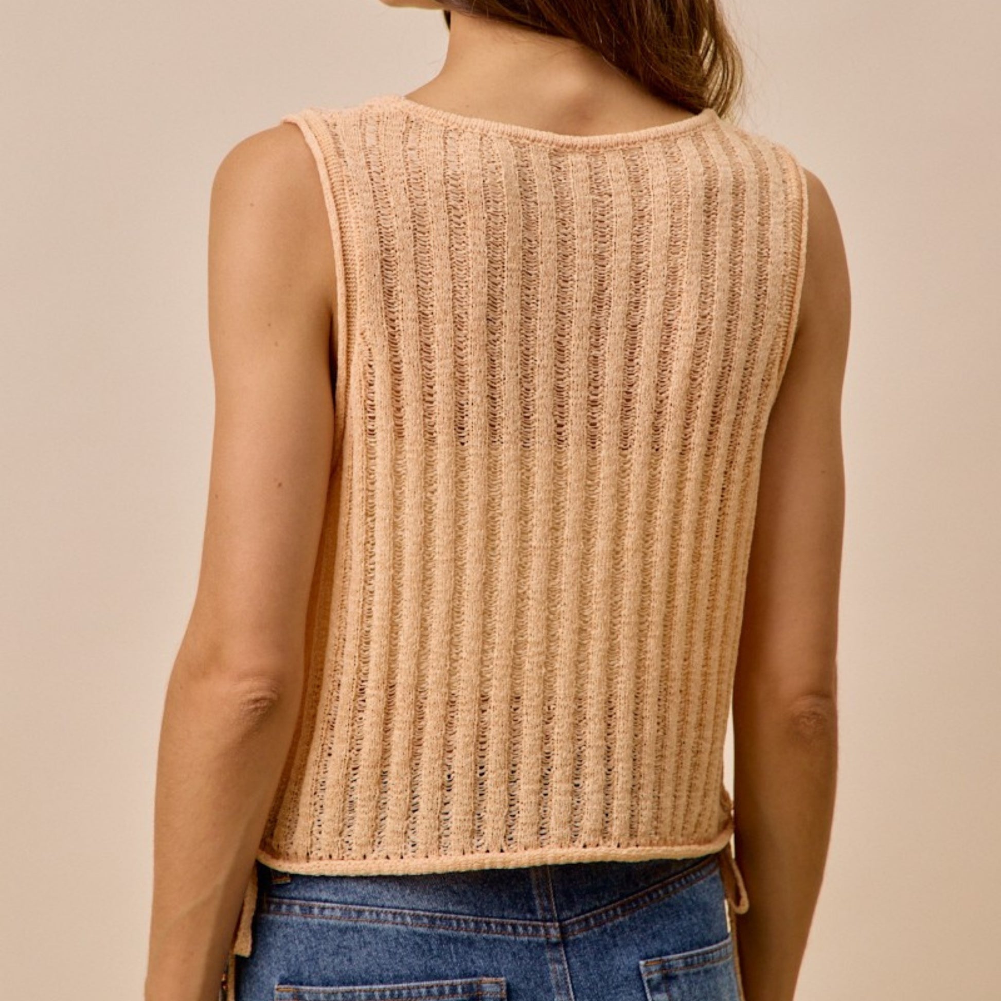 Back view of the SO ME peach sweater tank highlighting the relaxed fit.
