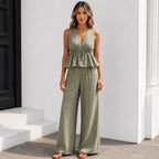 Women's sleeveless striped wide-leg pants two-piece set in olive green with a lightweight peplum top and flowy pants.