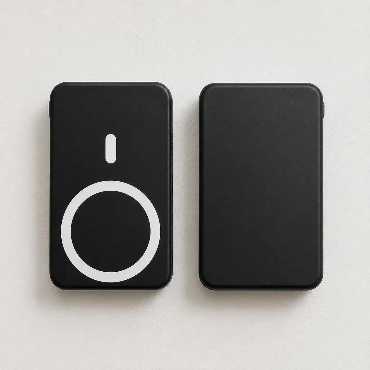 Small portable magnetic wireless power bank in black showing front and back