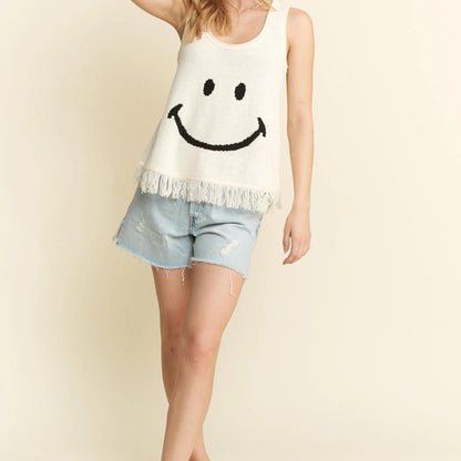Lifestyle view of the smiley face fringe tank styled for an effortless summer look.