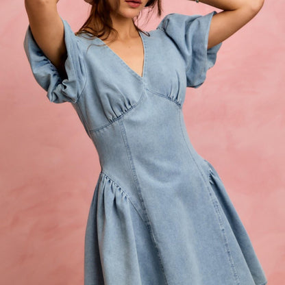 Lifestyle shot of the SO ME bubble sleeve denim dress styled for a casual outing.