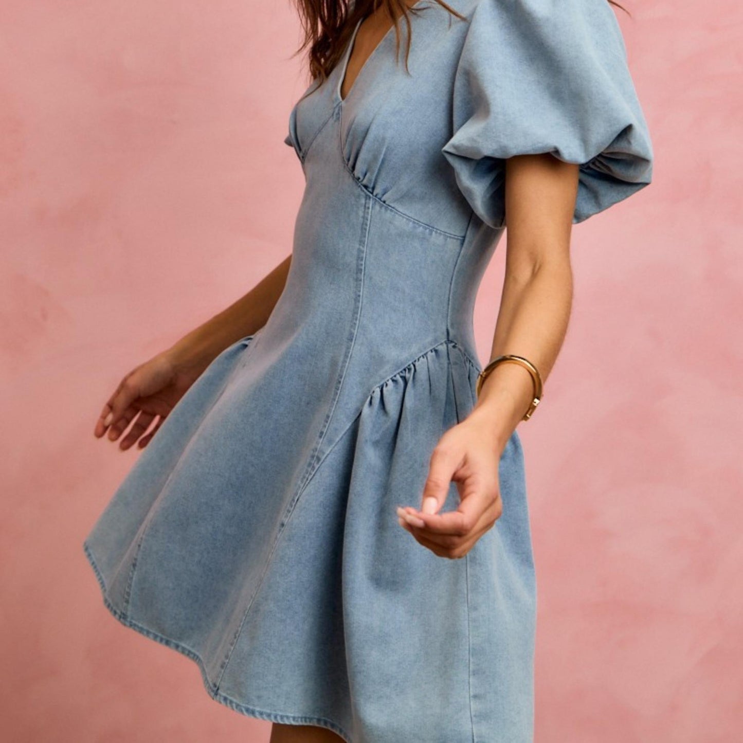 Side profile of the SO ME fit and flare denim mini dress showing the flared silhouette.
