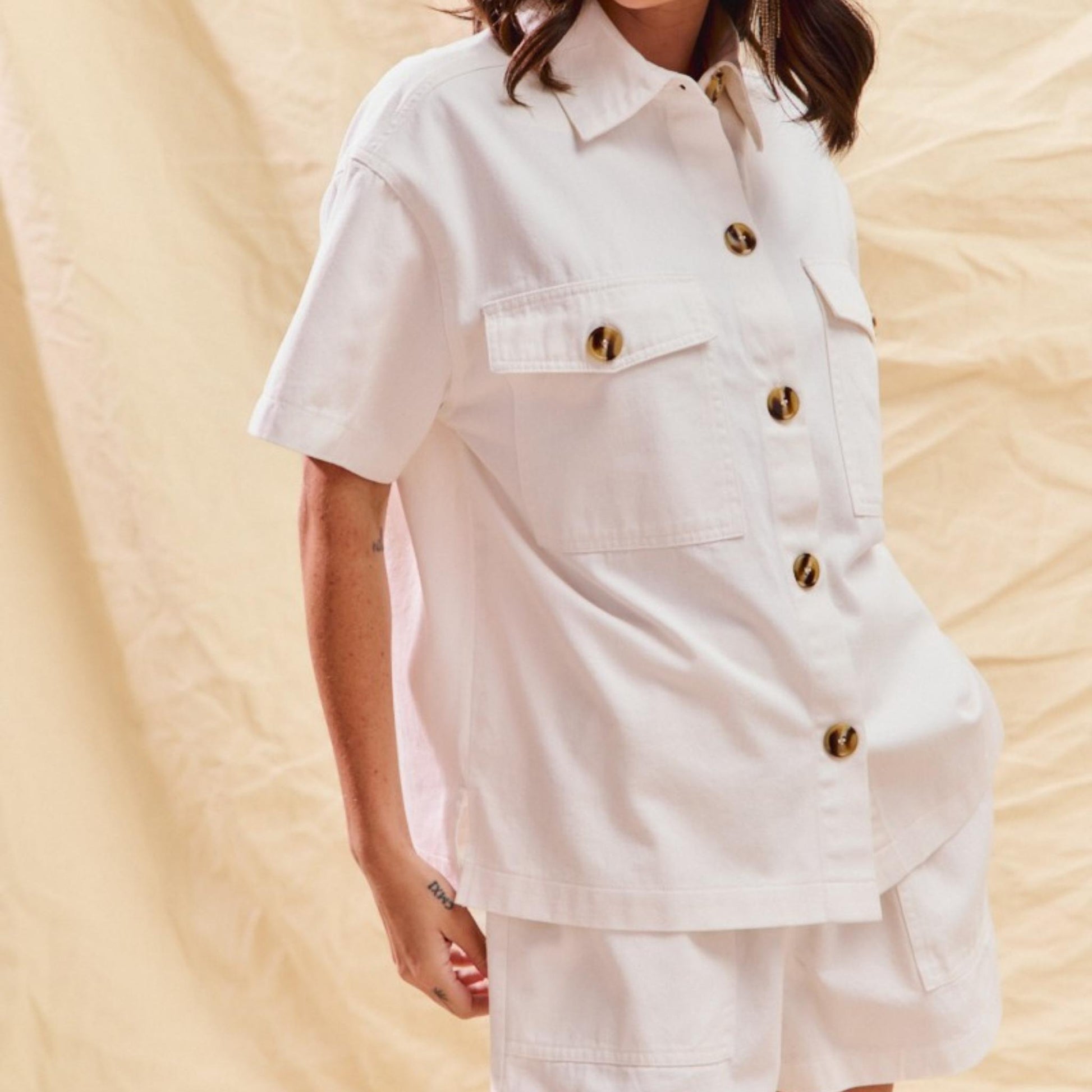 Detail view of the button-down denim top paired with matching shorts.