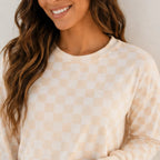 Close-up of soft checkered long-sleeve lounge set fabric and neckline