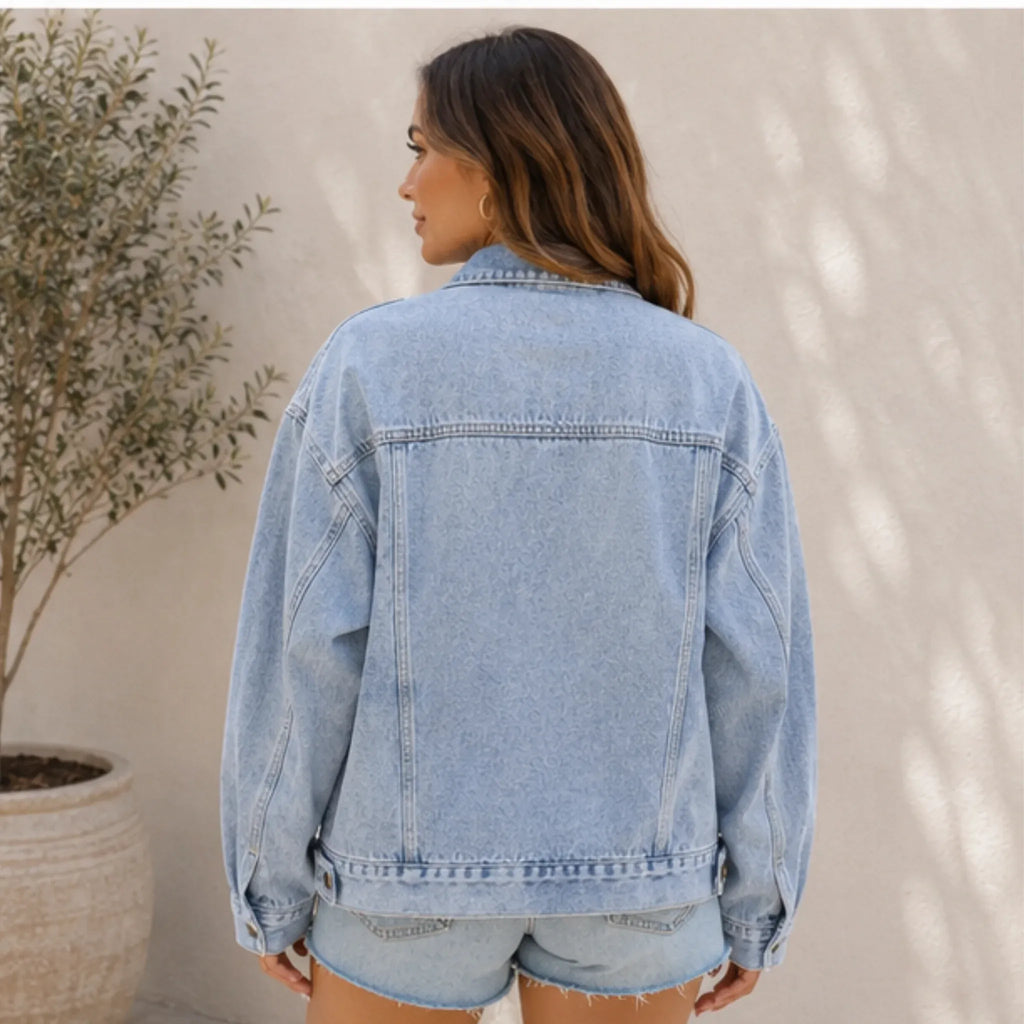 Back view of the women's Classic Relaxed Fit Jean Jacket in light blue showcasing the relaxed fit, structured yoke, and timeless denim design.