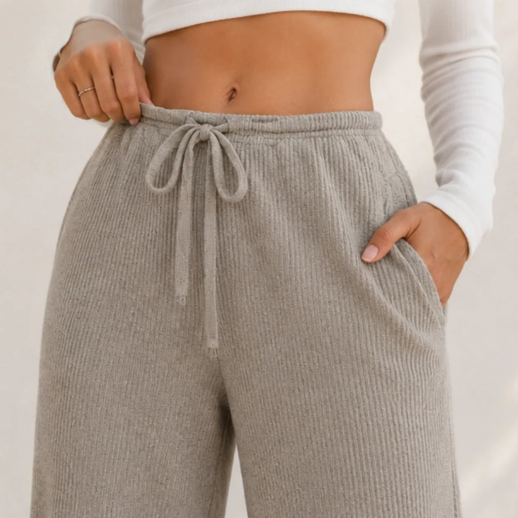 Close-up of khaki wide-leg pants showing drawstring waist, ribbed texture, and pocket