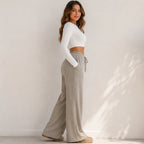 Side view of women's khaki wide-leg drawstring pants with relaxed fit