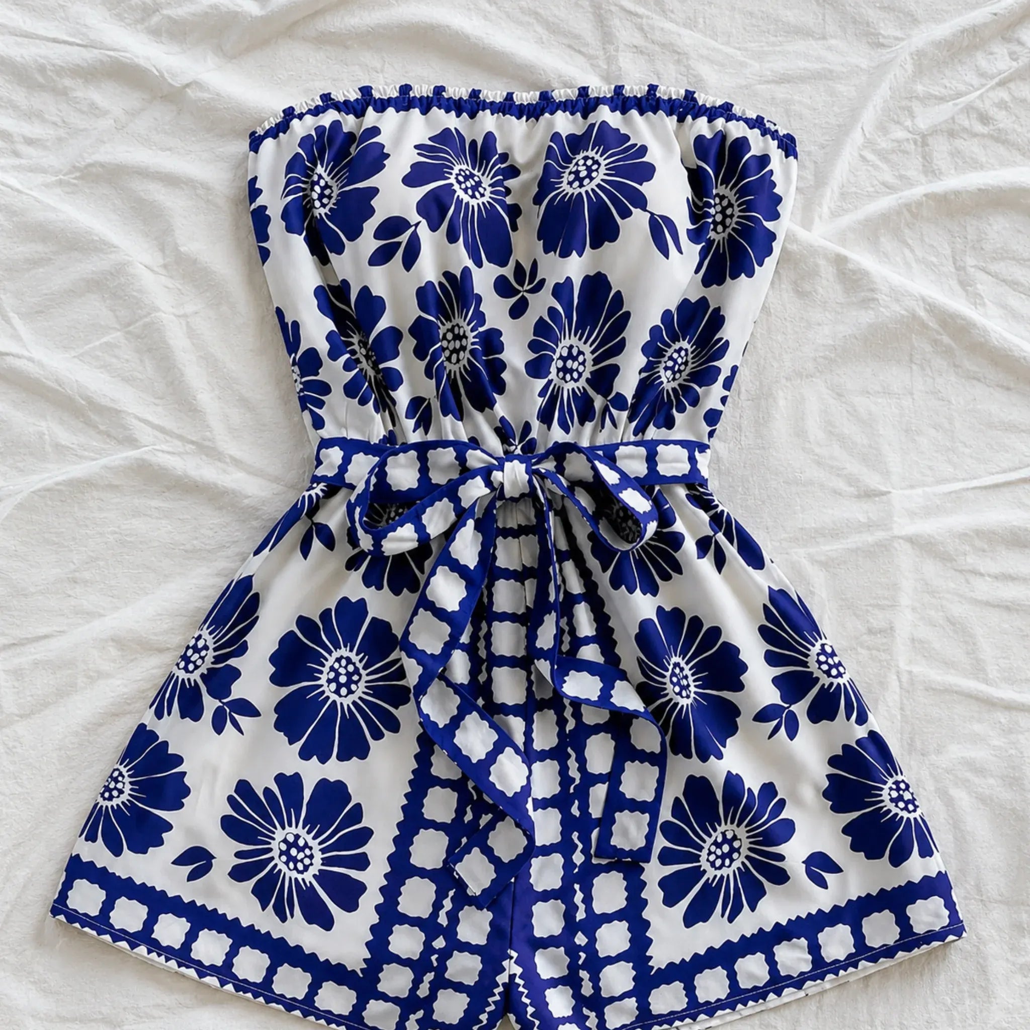 strapless-tie-waist-romper-blue-floral-print-flat-lay-solazura-boutique.webp