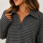 Close-up view of the striped collar and fabric detail on the black long-sleeve pants set