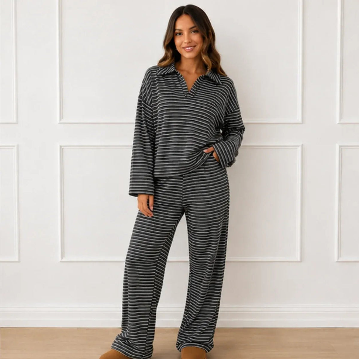Front view of a woman wearing the black striped collared long-sleeve top and wide-leg pants set
