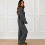Side view of the black striped collared long-sleeve top and wide-leg pants set