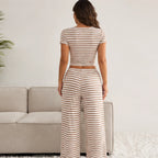 Back view of the khaki striped two-piece lounge set with cropped top and full-length wide-leg pants.