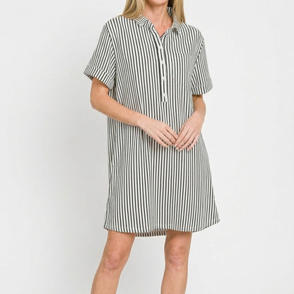 Close-up of the polished collar and half button-up detail on the black striped dress.