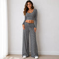 Black striped knit two-piece pants set with long-sleeve crop top and wide-leg pants