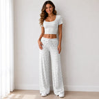 Gray striped knit two-piece pants set with short-sleeve crop top and wide-leg pants