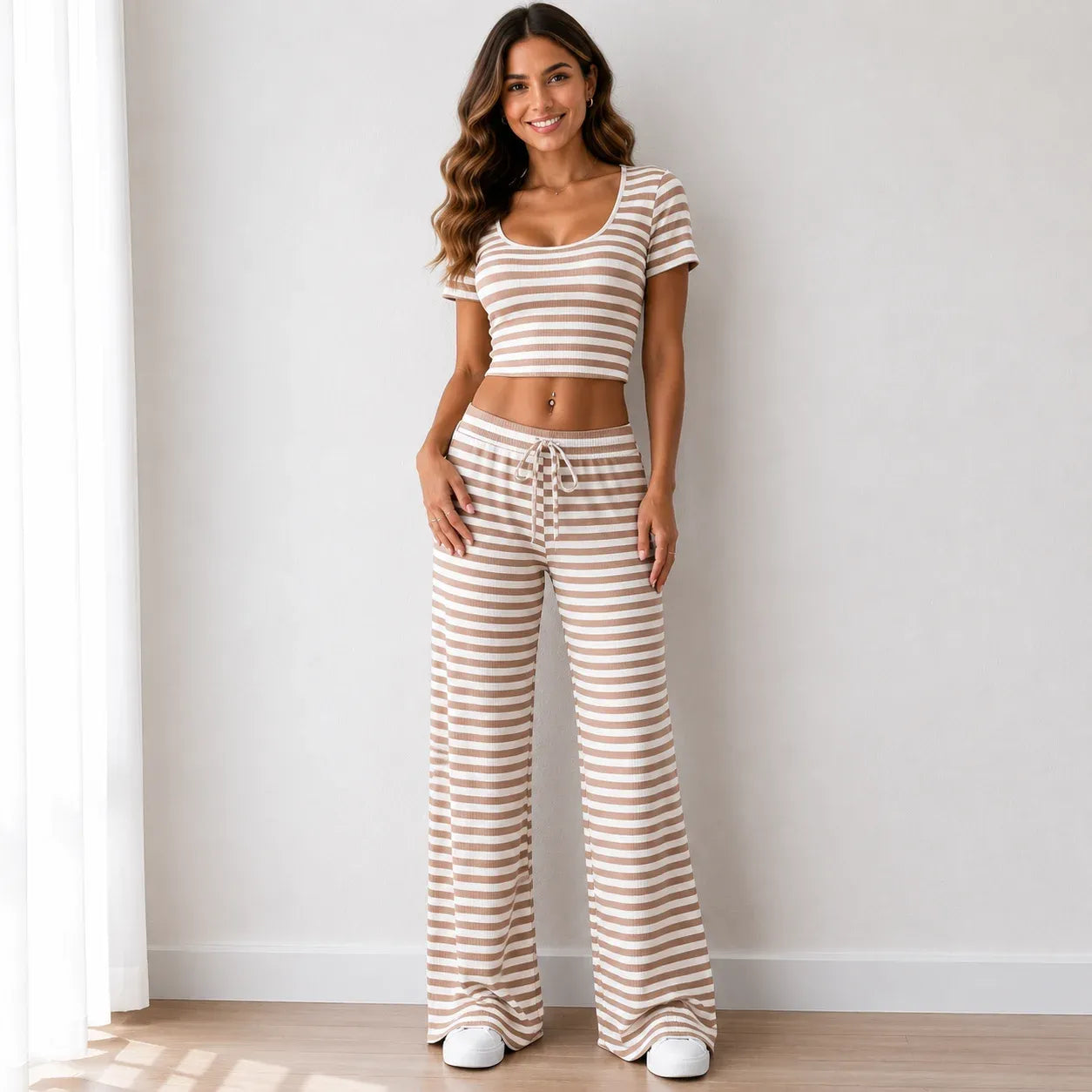 Tan striped knit two-piece pants set with short-sleeve crop top and wide-leg pants