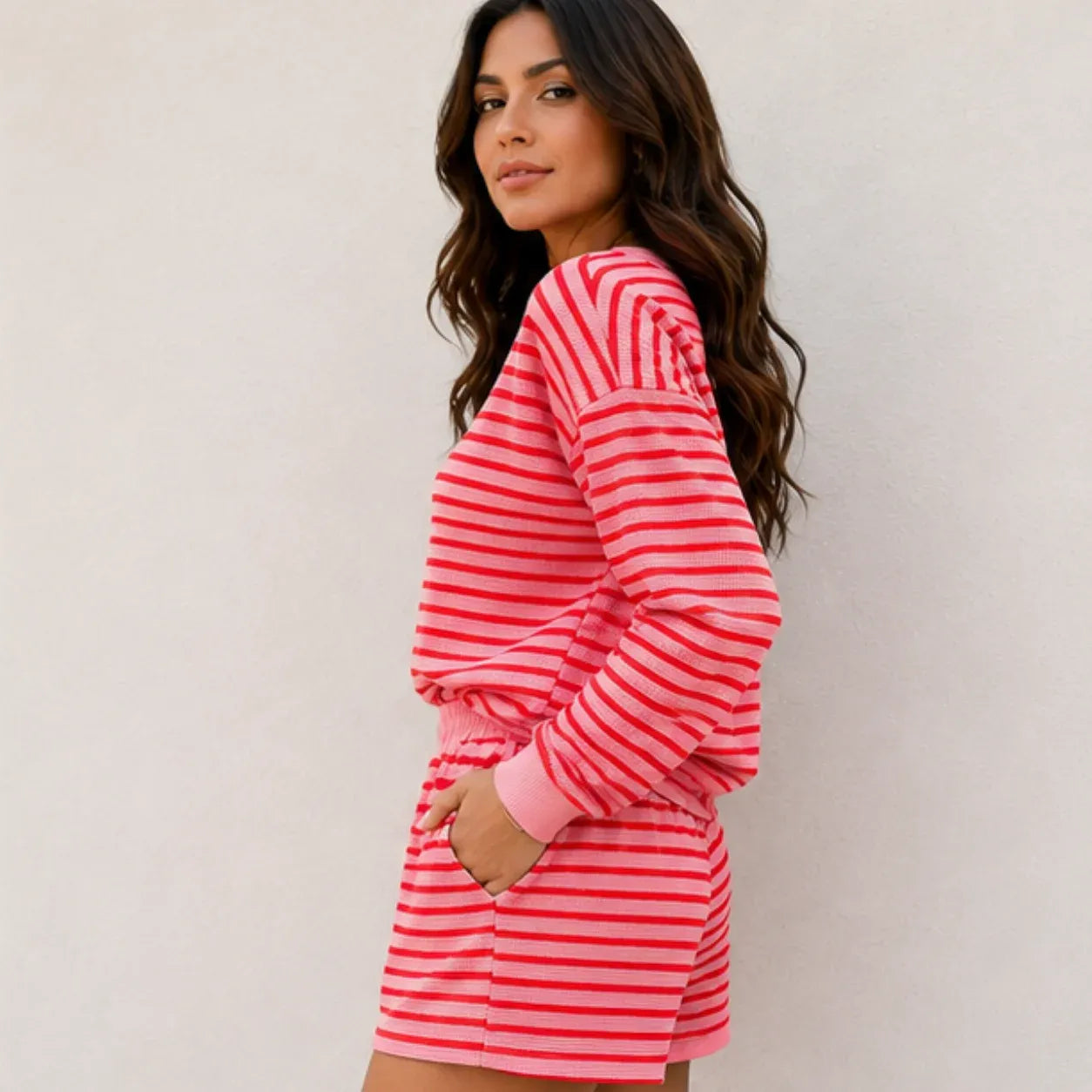 Side view of rose red striped long-sleeve top and shorts two-piece set