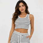 Woman wearing a white and black striped ribbed crop tank and lounge shorts set with front view.