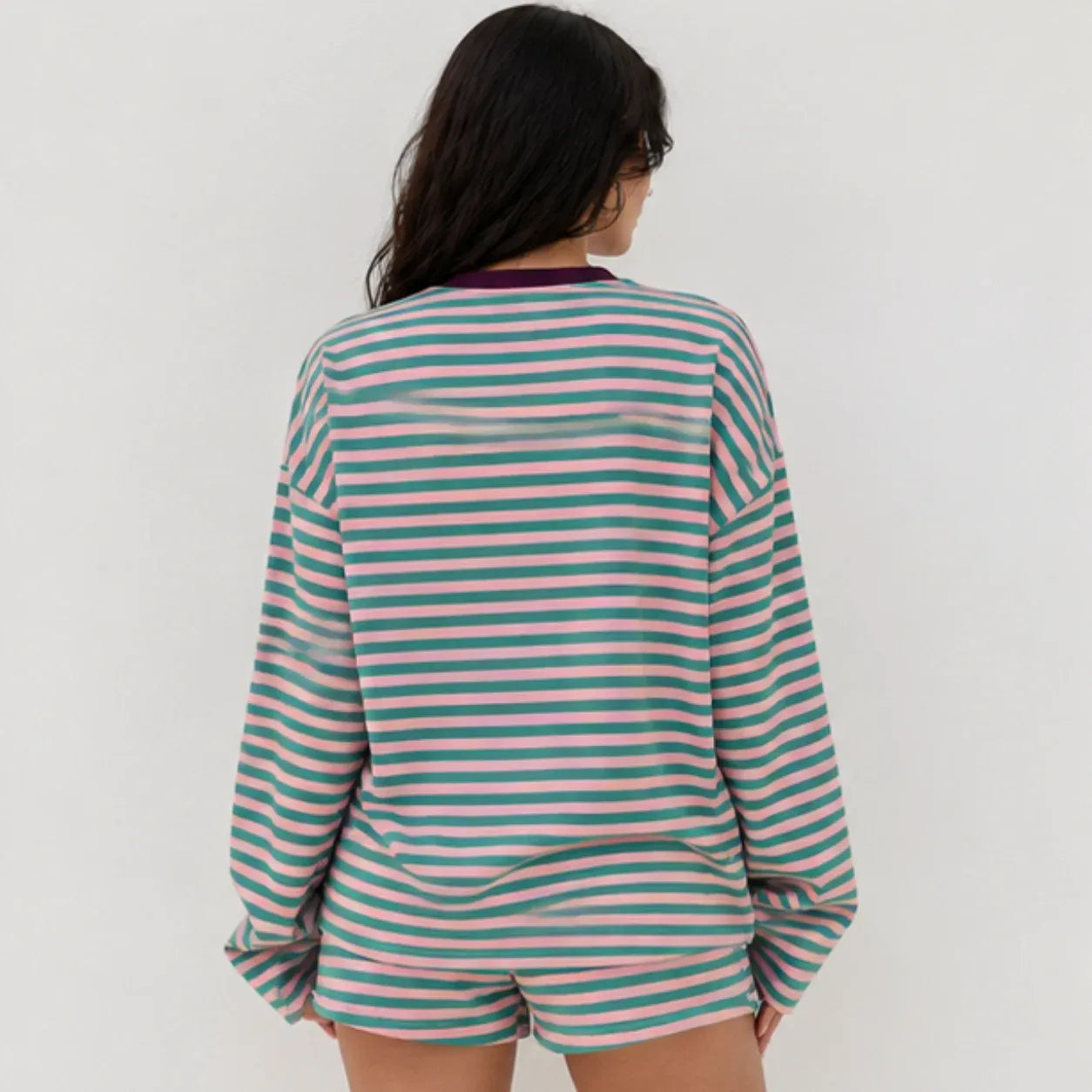 Back view of women's relaxed fit pink and teal green striped long-sleeve lounge shorts set
