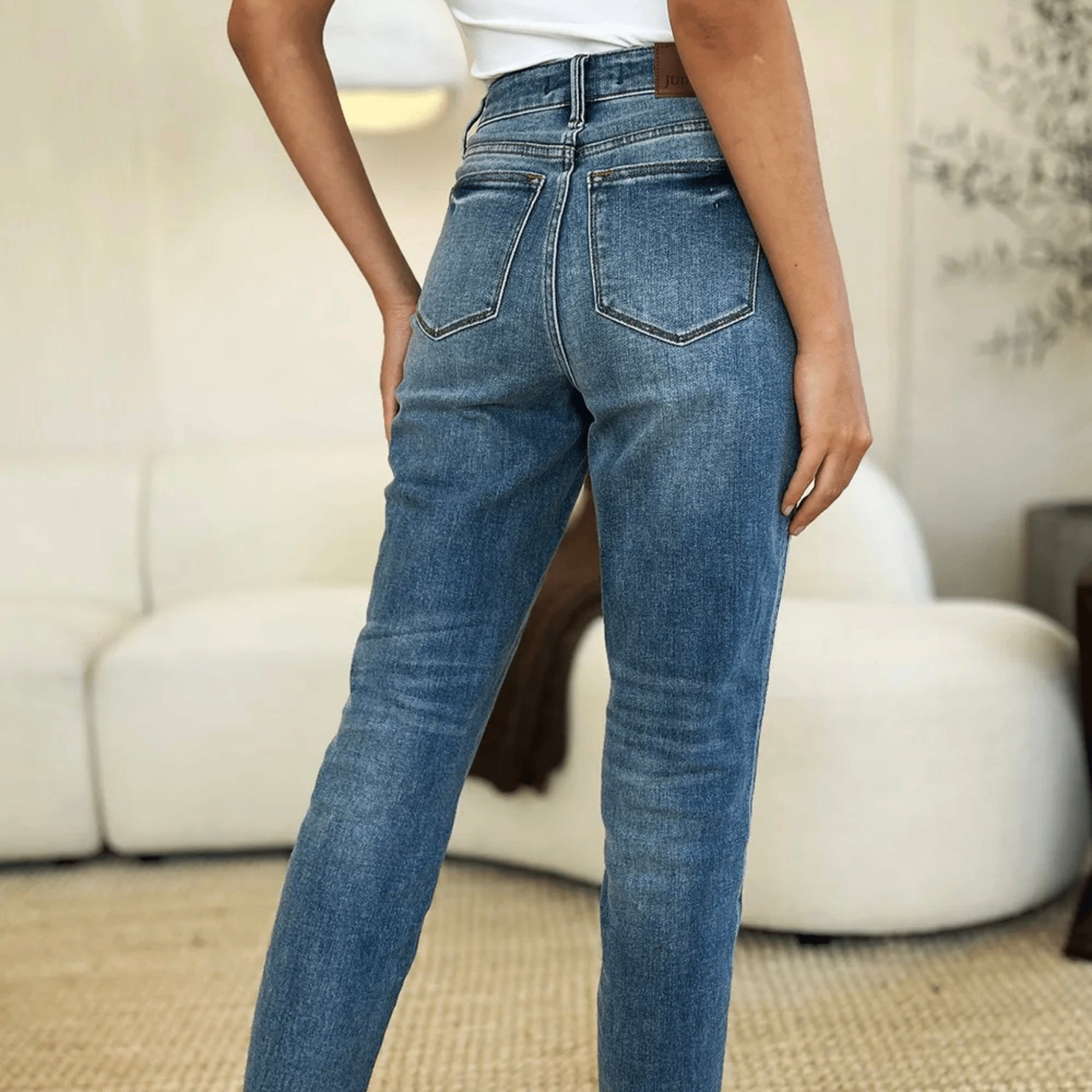 Back view of structured medium wash jeans showing the flattering fit and pockets.
