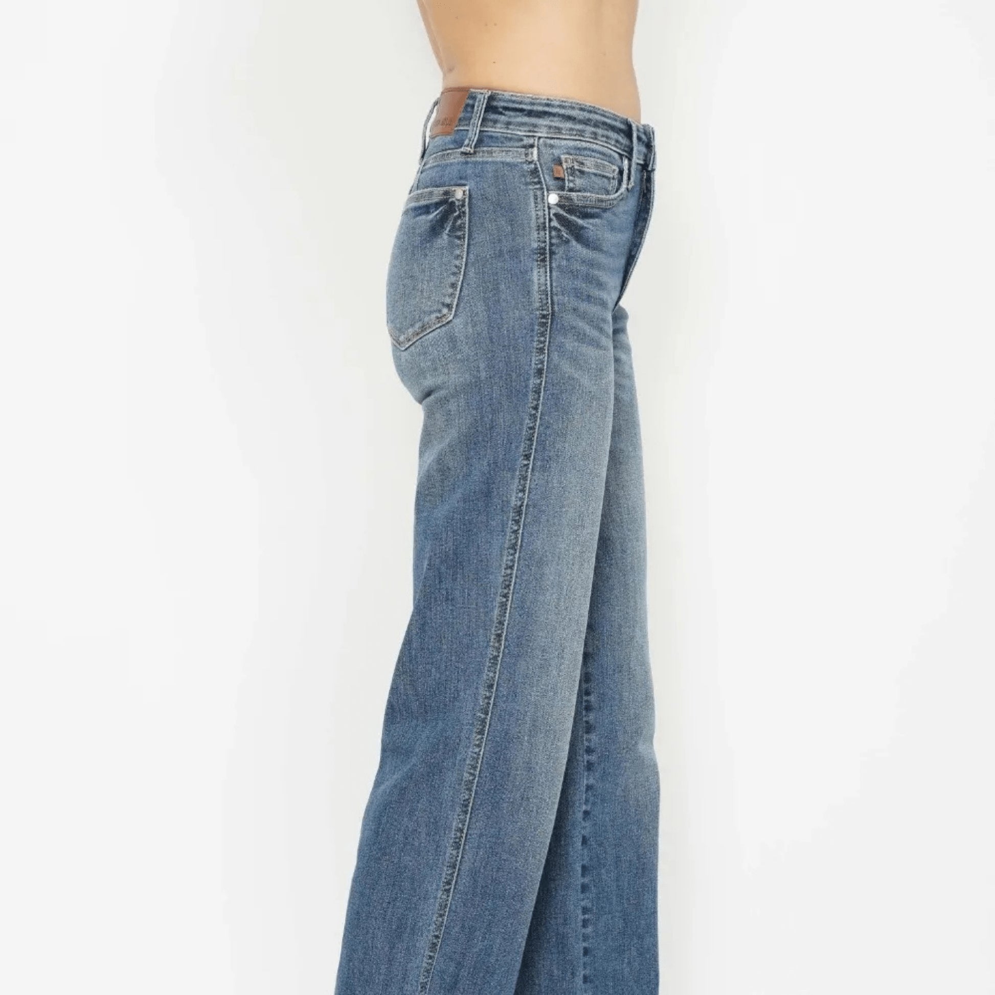 Front view of medium wash straight jeans highlighting the sculpting high-rise fit.
