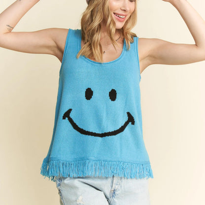 Detailed view of the turquoise smiley face tank and denim shorts.