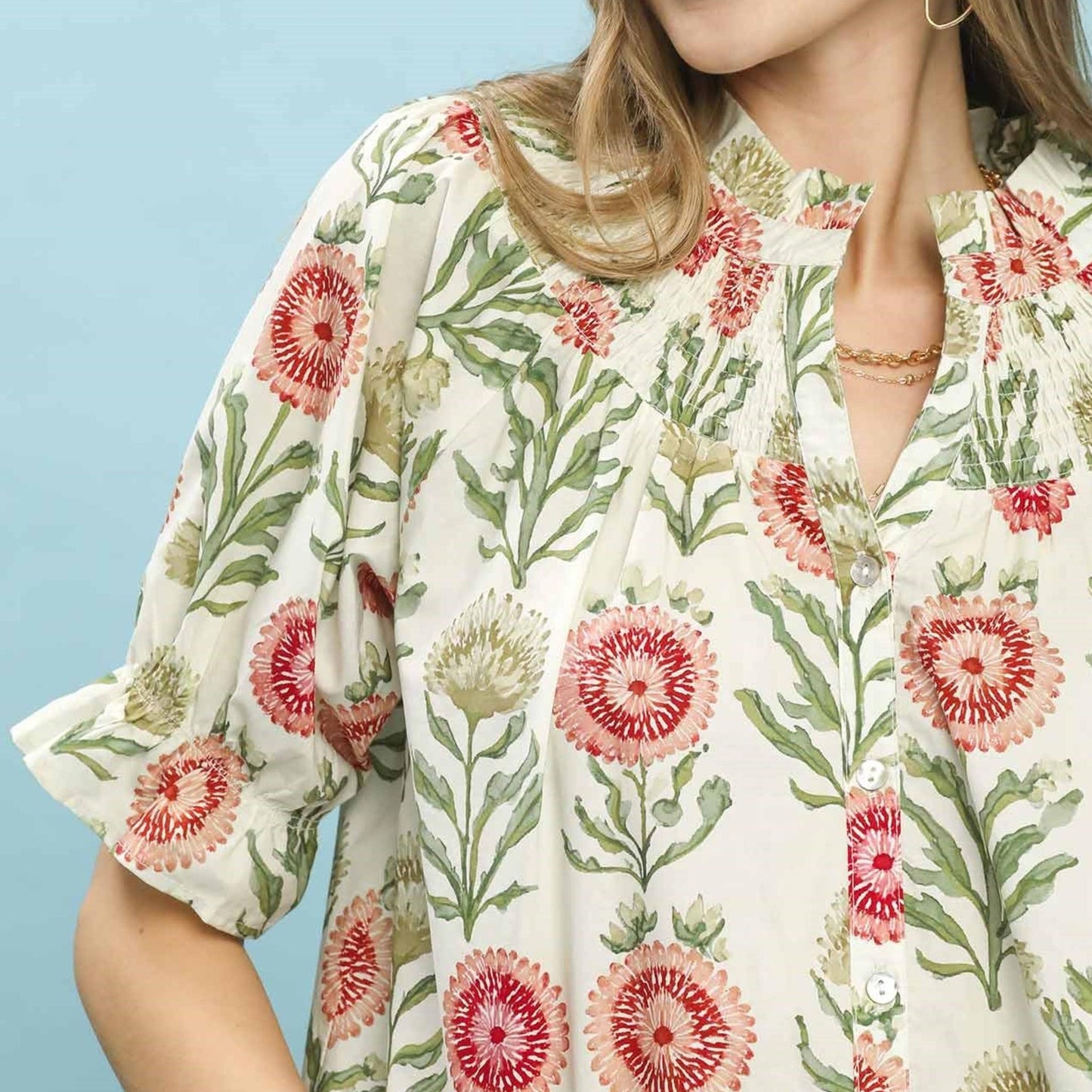 Close-up of the functional button-front and botanical floral pattern on the Umgee short sleeve top.
