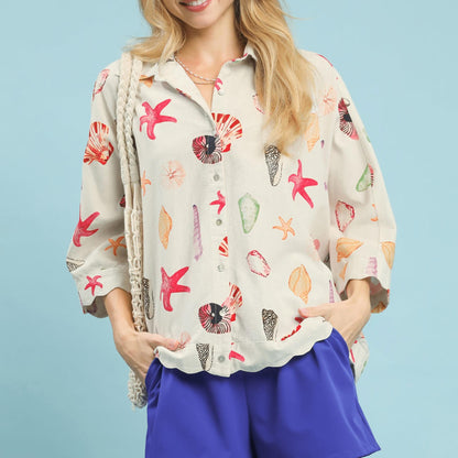 Front view of the Umgee seashell and starfish print button-down top in coral mix.