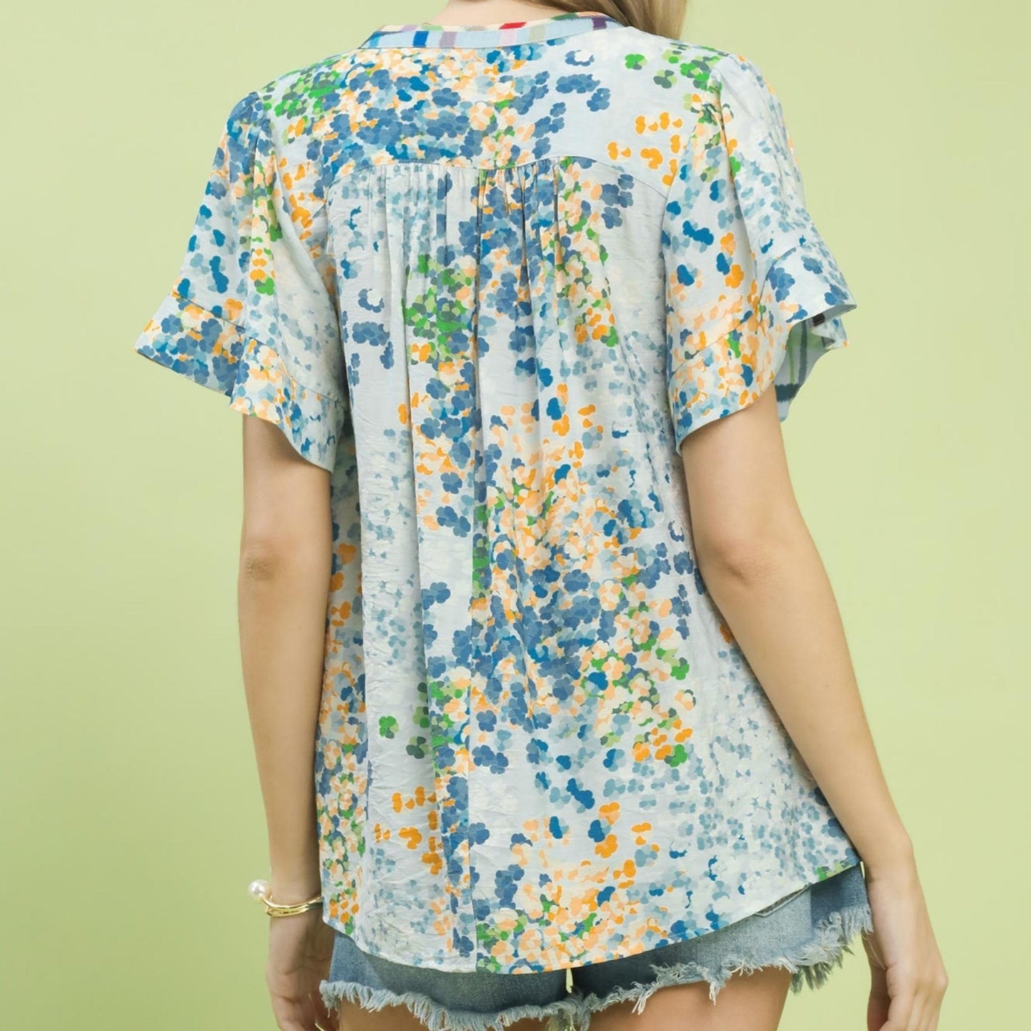 Back view of the lightweight floral blouse showing the flowy, breezy silhouette.