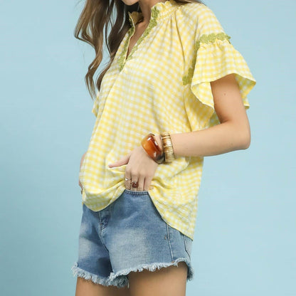 Side profile of the Umgee gingham lace trim top highlighting the ruffled sleeves.