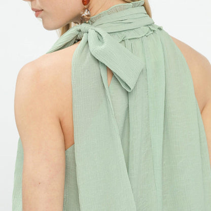 Close-up of the adjustable tie-neck and back keyhole on the Umgee mint chiffon blouse.
