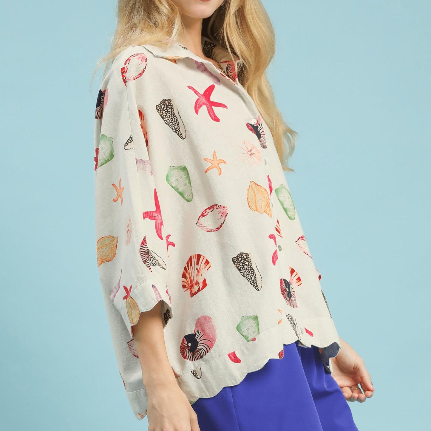 Side profile of the seashell print button-down top showing the airy, relaxed fit.