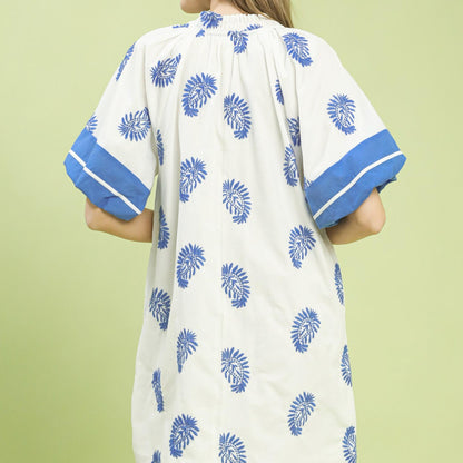 Back view of the off white embroidered mini dress highlighting the breathable cotton fabric.