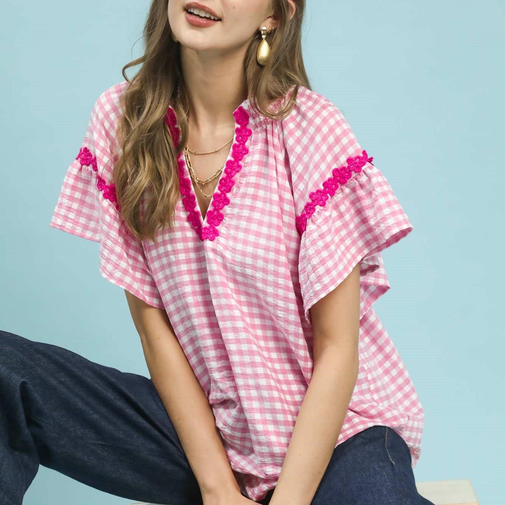 Detailed view of the intricate lace trim and embroidery on the Umgee Peony top.