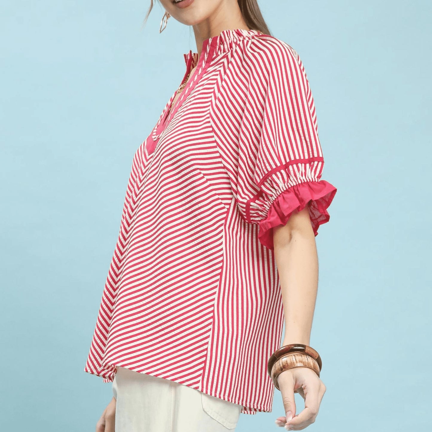 Close-up of the modern split-neckline and raspberry vertical stripes.