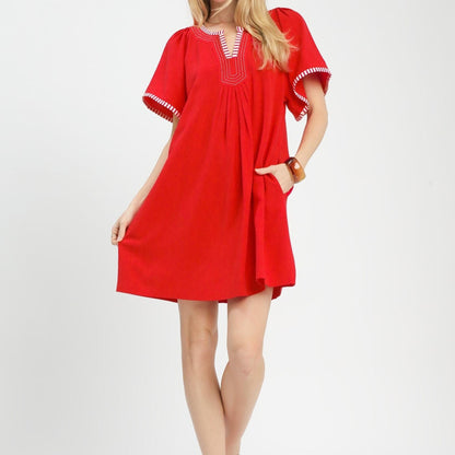 Full-length lifestyle view of the Umgee red flutter sleeve tunic dress paired with sandals.