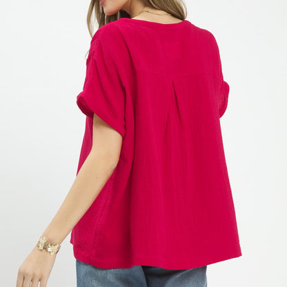 Back view of the red 100% cotton gauze blouse highlighting the soft, textured fabric.
