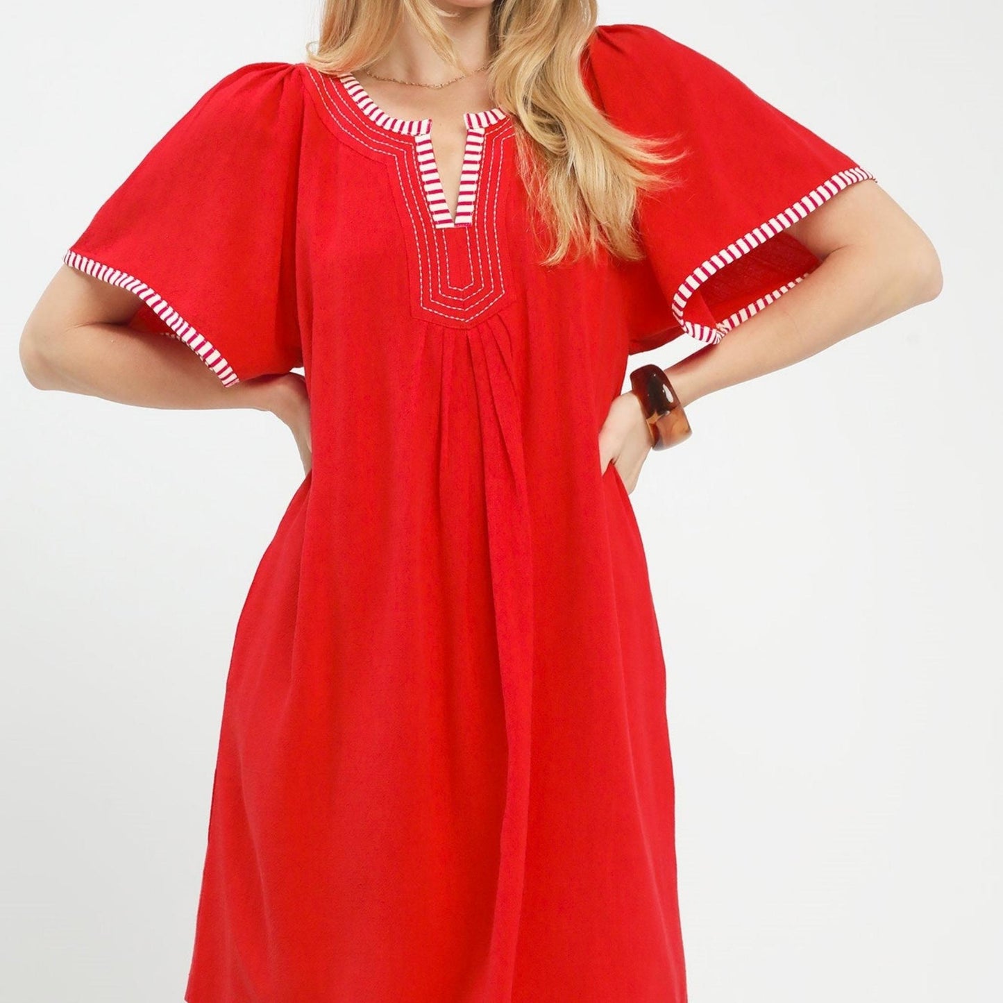 Front view of the red Umgee linen trim tunic dress with flutter sleeves.