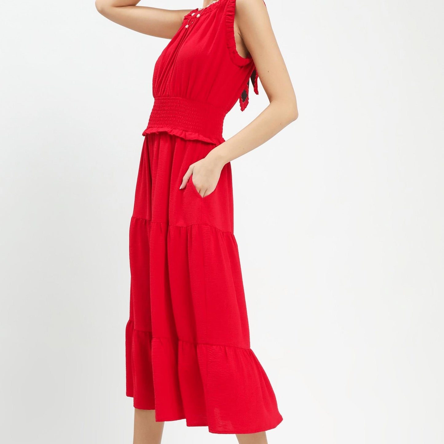 Side profile of the cherry red tiered midi dress showing the flowy skirt layers.