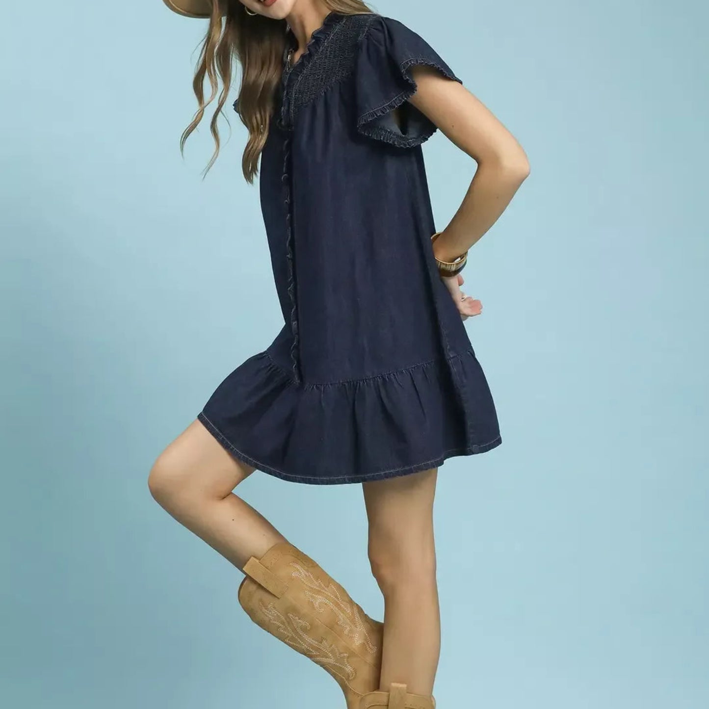 Woman wearing the umgee ruffled washed denim dress for a casual and feminine everyday look