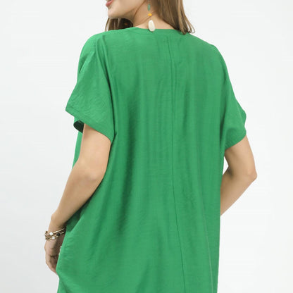 Back view of the Umgee Apple Green blouse showcasing the relaxed fit and high-low hemline.