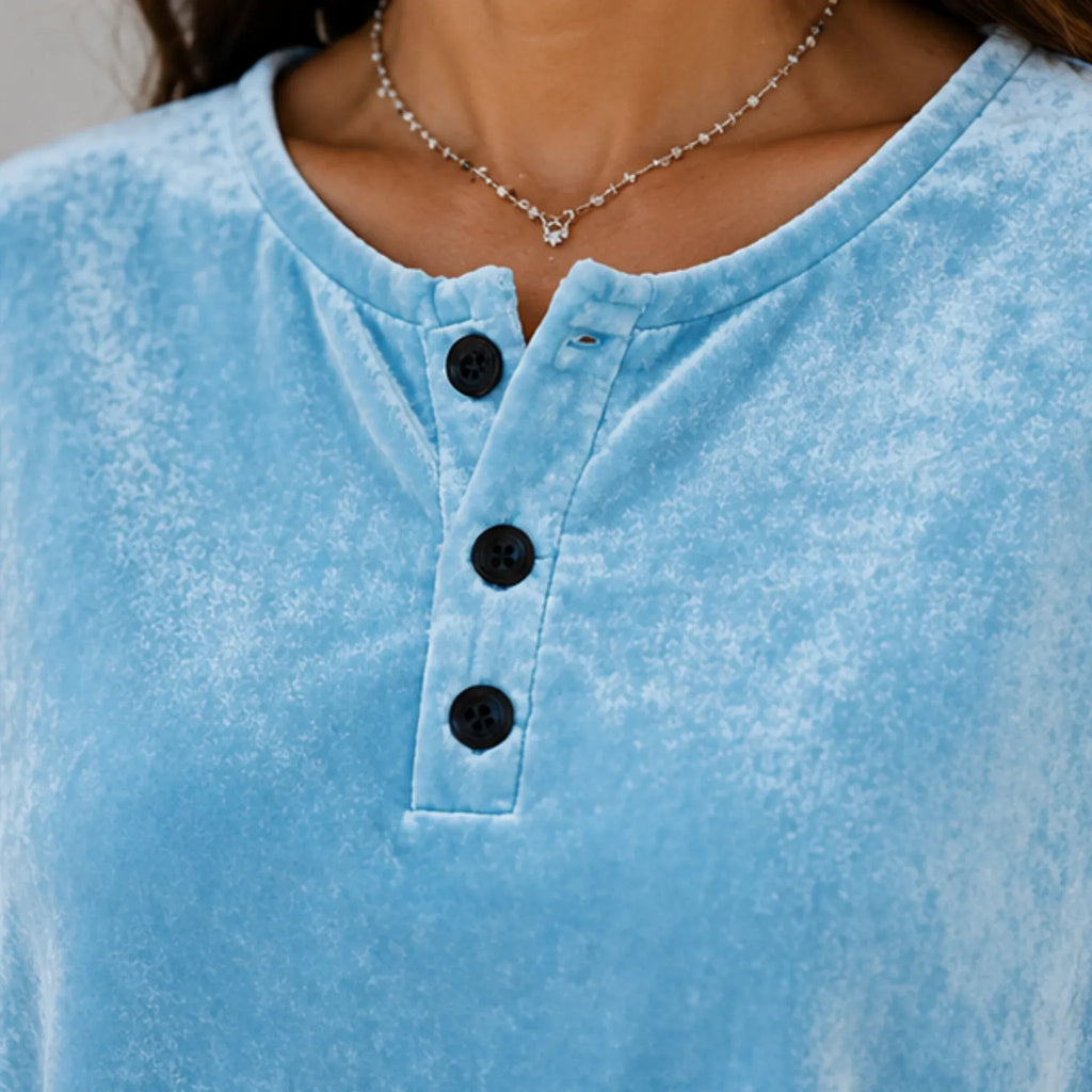 Close-up of the sky blue Velvet Henley Sweatshirt showcasing the Henley button placket and luxurious brushed velvet texture.