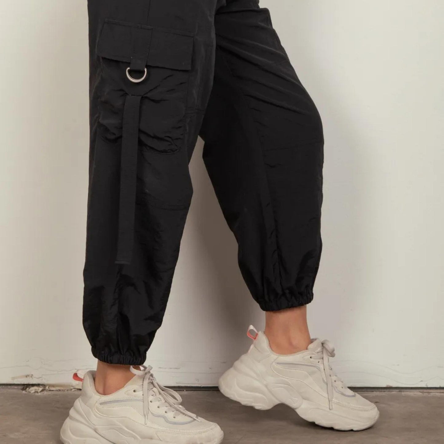 Very J black woven cargo pants showing side pocket and D-ring accents.