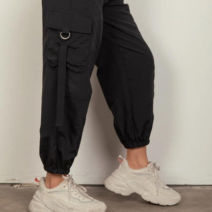 Very J black woven cargo pants showing side pocket and D-ring accents.