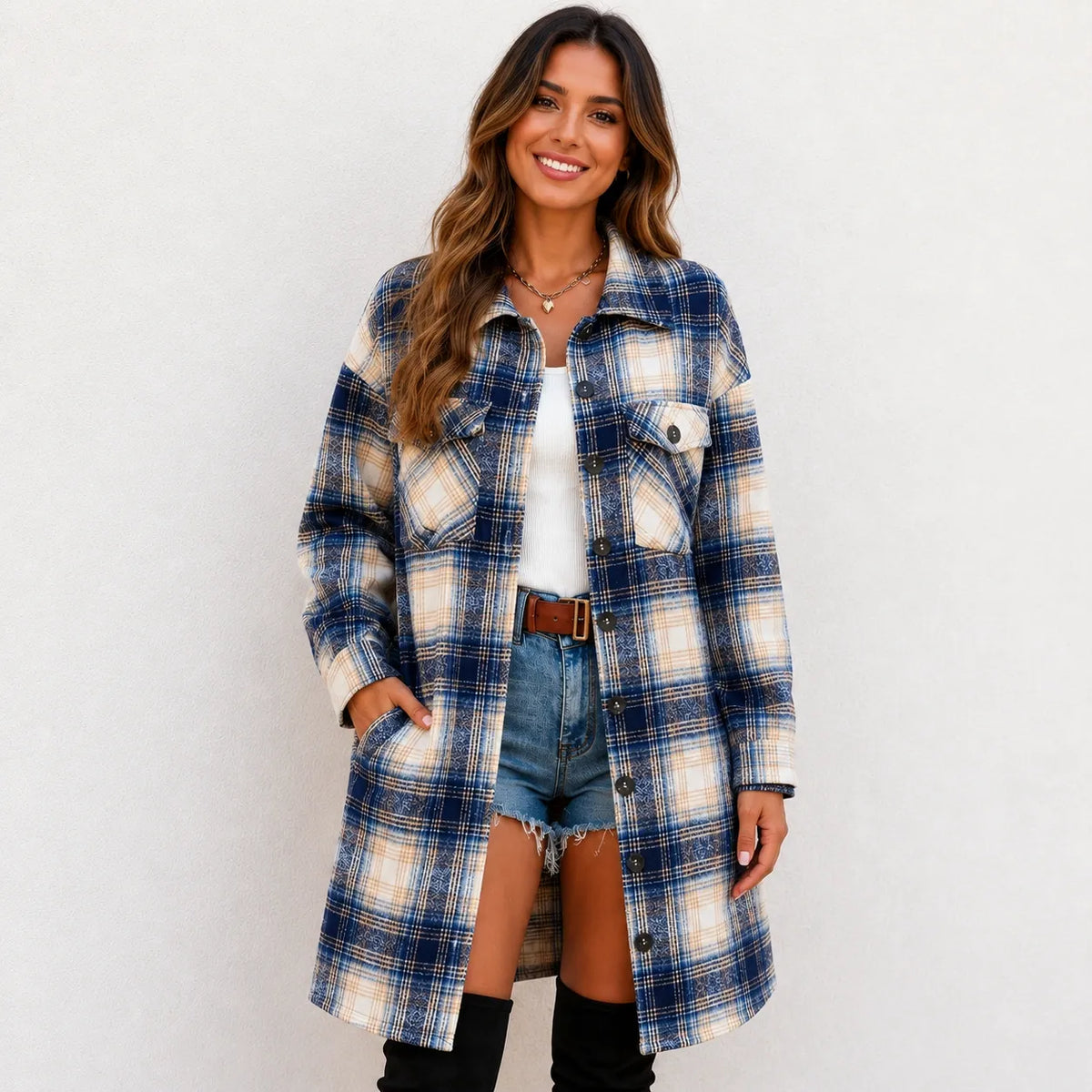 Woman wearing a blue and cream plaid long cardigan shirt jacket with button front and pockets