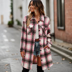 Woman wearing a pink and black plaid long cardigan shirt jacket with button front and pockets