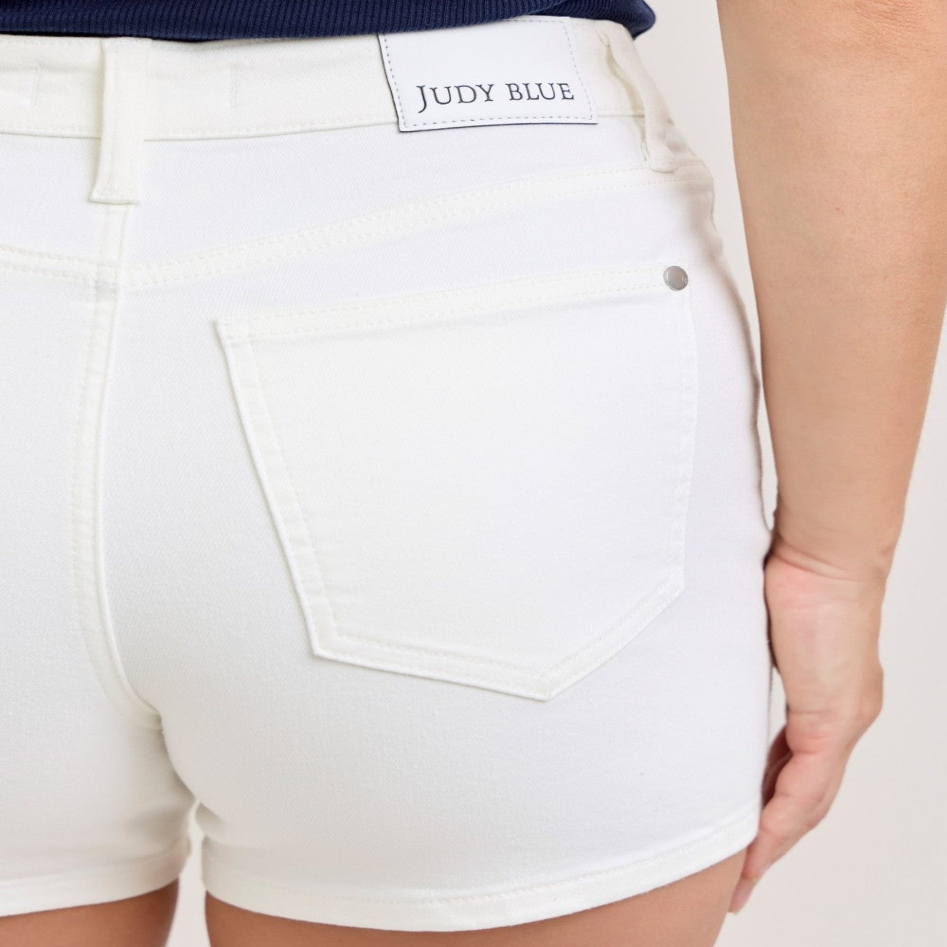 Close-up of the white denim material and stitching on Judy Blue slim shorts.