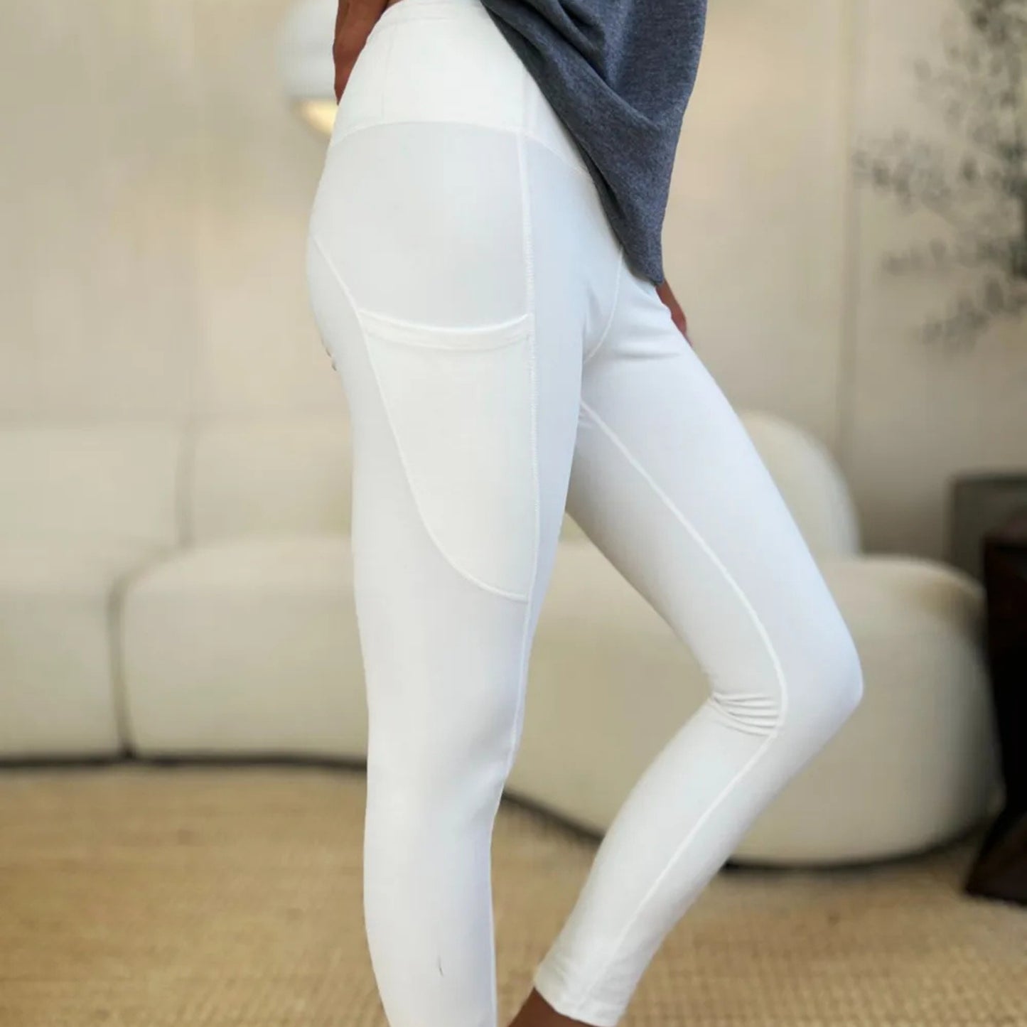 White leggings worn by a person in a home setting