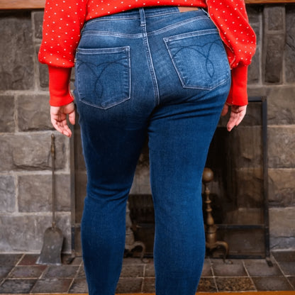 Full-body styling shot of thermal skinny jeans paired with winter boots and a cozy sweater.